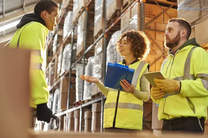 Warehouse trainer assisting trainee